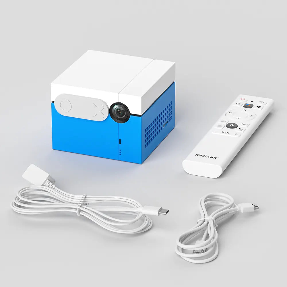 Blue and white portable projector with remote control and cables on a light gray background