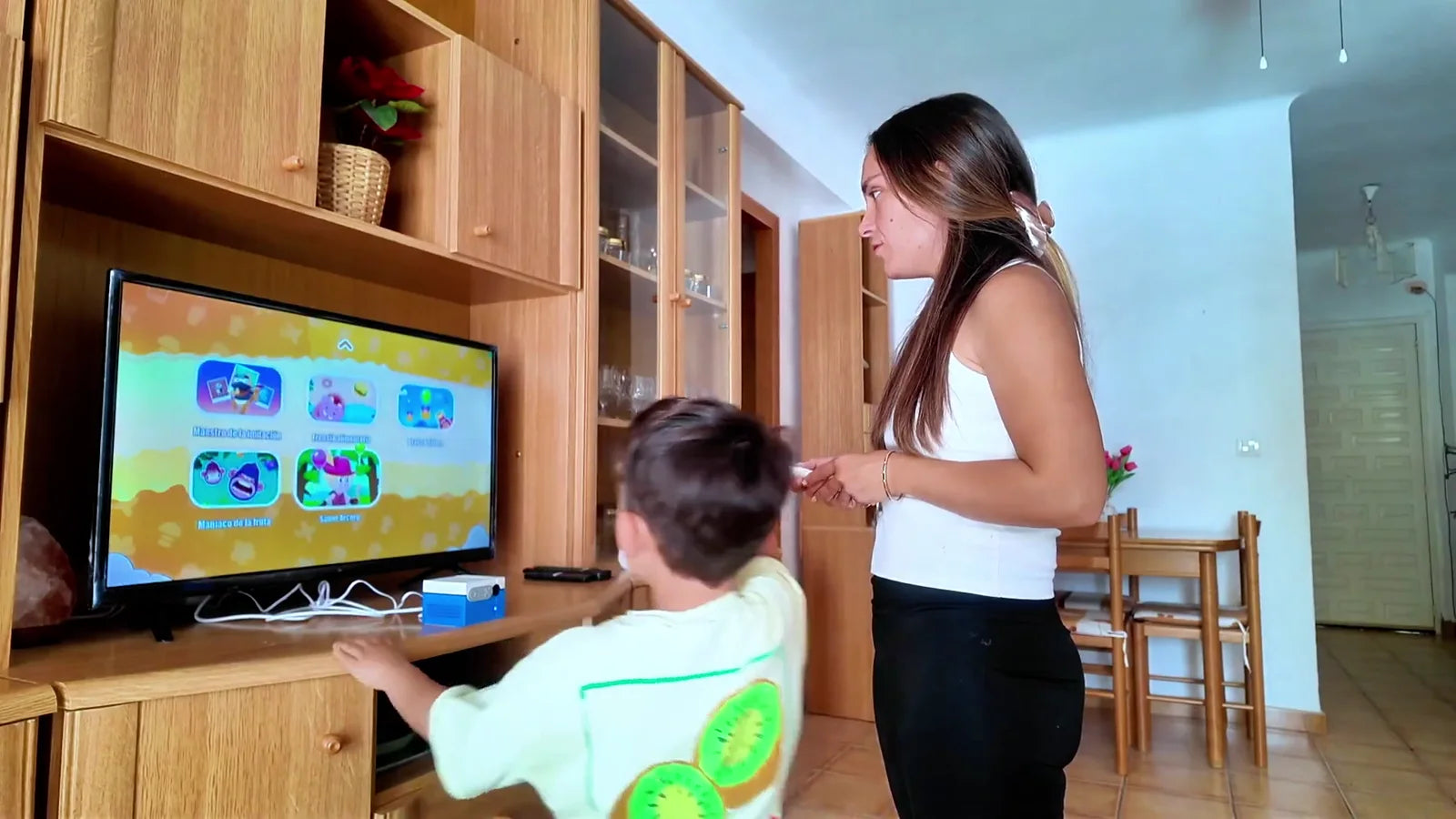 Man and child playing a video game on a large screen with text promoting family fun and health.